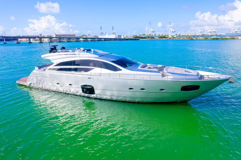  Yacht Photos Pics Luxurious 2013 Pershing 82 yacht cruising on vibrant blue-green waters.