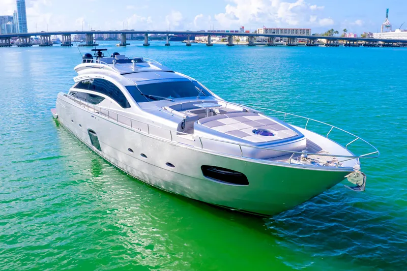  Yacht Photos Pics Luxury 2013 Pershing 82 yacht cruising on turquoise waters near a bridge.