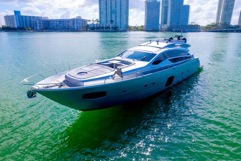  Yacht Photos Pics Luxurious 2013 Pershing 82 yacht cruising in a scenic waterfront cityscape.