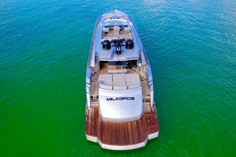  Yacht Photos Pics Luxurious 2013 Pershing 82 yacht on vibrant green water, aerial view.
