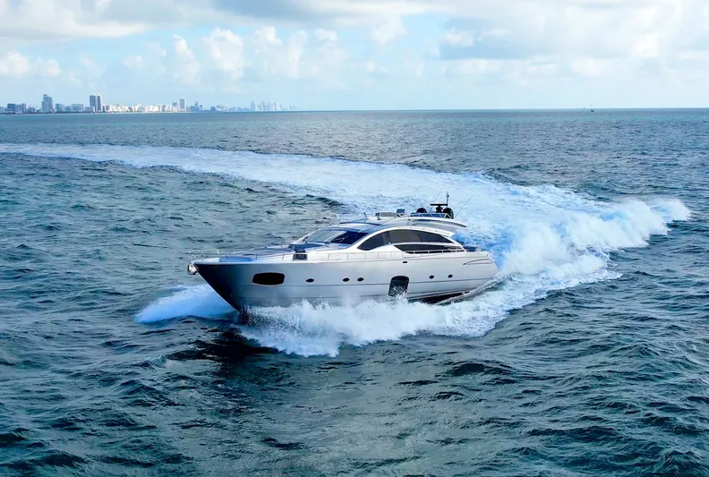  Yacht Photos Pics Luxury 2013 Pershing 82 yacht cruising on open sea under clear skies.