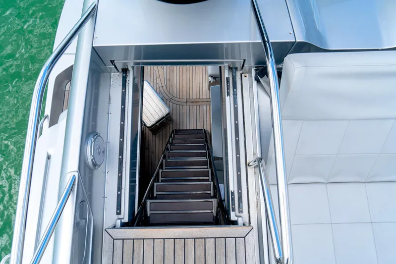  Yacht Photos Pics Staircase on 2013 Pershing 82 yacht, leading to lower deck with wooden flooring.