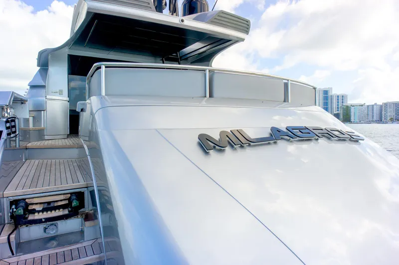  Yacht Photos Pics Luxury Pershing 82 yacht from 2013, docked with city skyline in background.