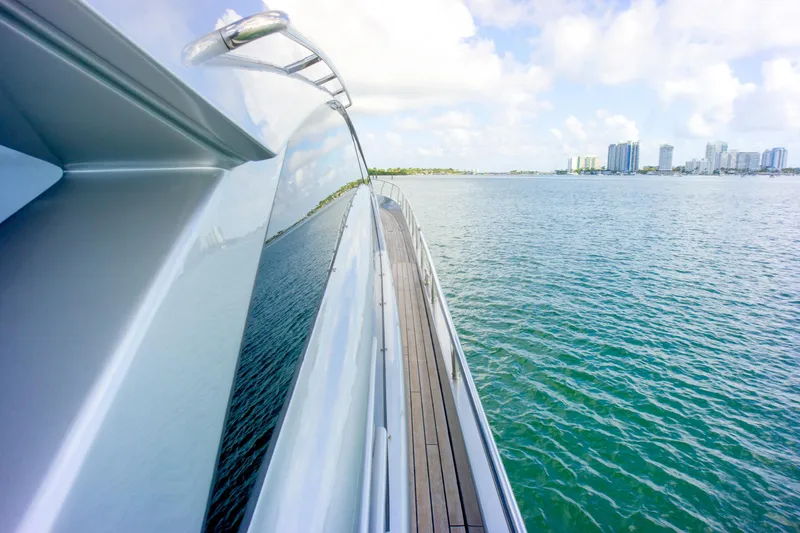  Yacht Photos Pics 2013 Pershing 82 yacht cruising on calm waters with city skyline in background.