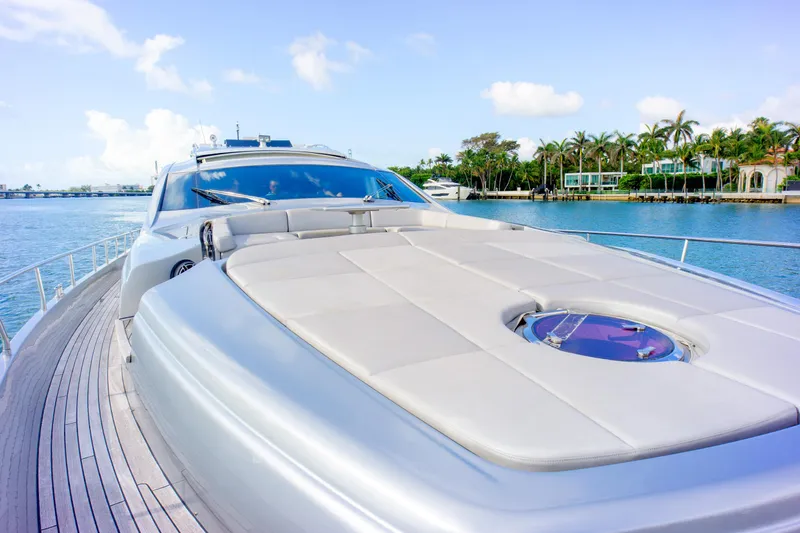  Yacht Photos Pics Luxury 2013 Pershing 82 yacht on serene water with palm trees in background.