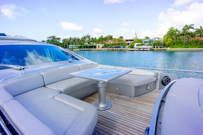  Yacht Photos Pics Luxurious 2013 Pershing 82 yacht with elegant seating, docked by a scenic waterfront.