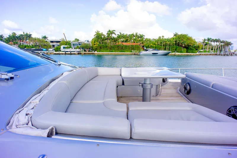  Yacht Photos Pics Luxurious seating area on 2013 Pershing 82 yacht, overlooking serene waterfront scenery.