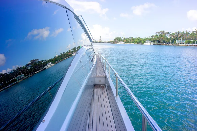  Yacht Photos Pics Side view of 2013 Pershing 82 yacht cruising on clear blue water.