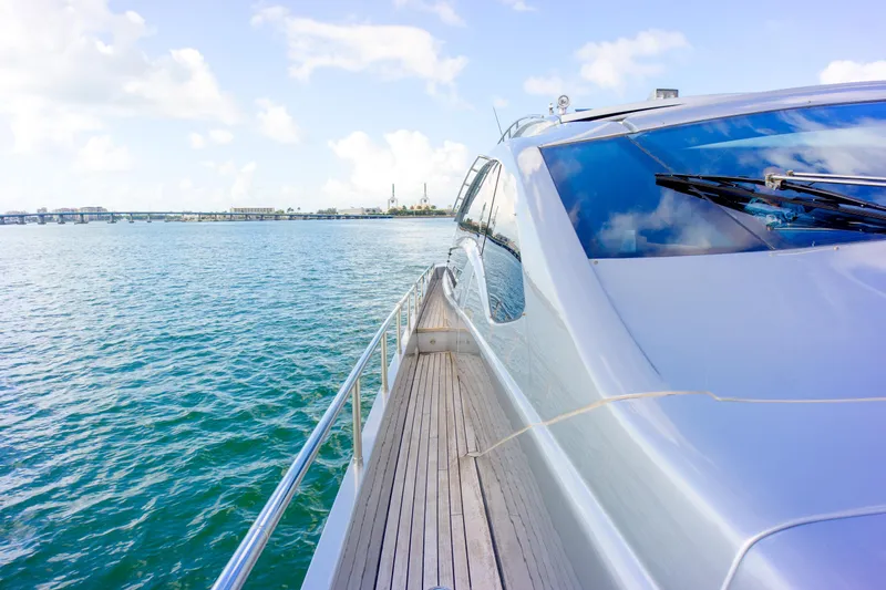  Yacht Photos Pics Luxurious 2013 Pershing 82 yacht cruising on serene blue waters under a clear sky.