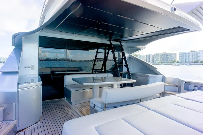  Yacht Photos Pics Luxurious 2013 Pershing 82 yacht deck with seating, table, and ocean view.