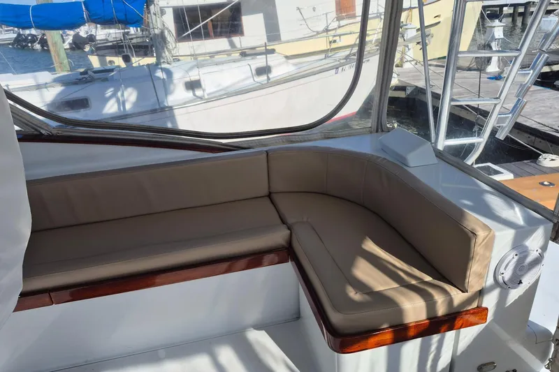 M.a.c. Daddy Yacht Photos Pics Interior seating of 2005 Custom Carolina 40 DeSanti boat with beige cushions.