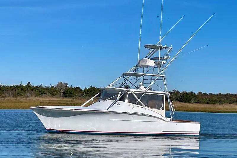M.a.c. Daddy Yacht Photos Pics 2005 Custom DeSanti Carolina Express boat on calm water under clear blue sky.