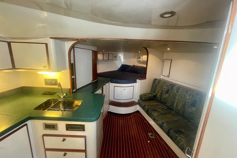 M.a.c. Daddy Yacht Photos Pics Interior of 2005 Custom DeSanti Carolina Express boat with kitchenette and seating area.