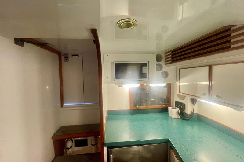 M.a.c. Daddy Yacht Photos Pics Interior of 2005 Custom DeSanti Carolina Express with green countertop and microwave.