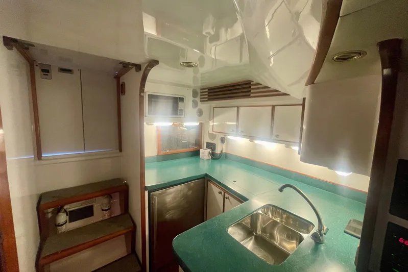 M.a.c. Daddy Yacht Photos Pics Interior of 2005 Custom DeSanti Carolina Express boat with modern kitchen amenities.