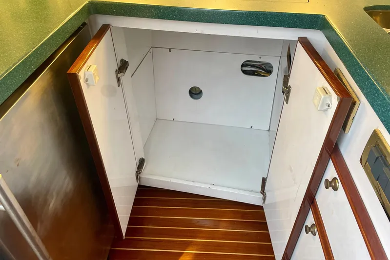 M.a.c. Daddy Yacht Photos Pics Open cabinet in 2005 Custom DeSanti Carolina Express boat kitchen with wooden floor.