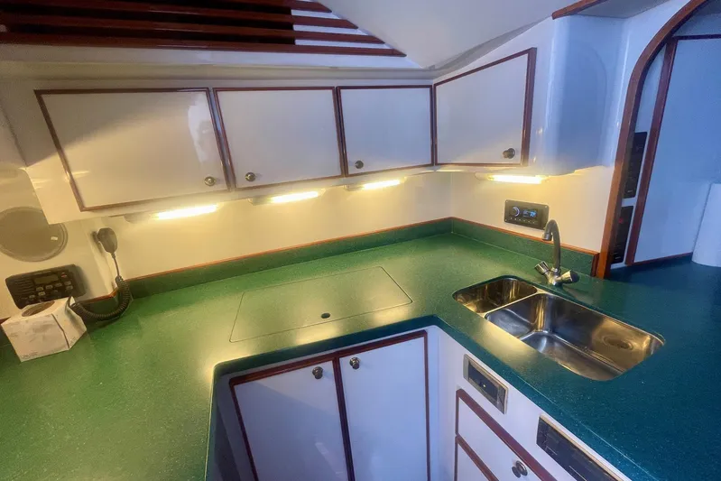 M.a.c. Daddy Yacht Photos Pics Luxurious 2005 Custom DeSanti Carolina Express yacht kitchen with green countertops and modern fixtures.