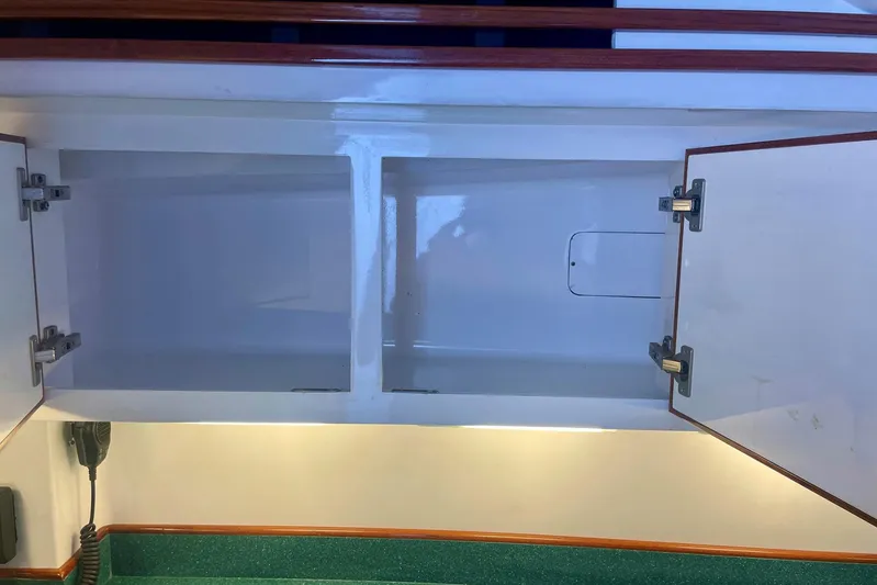 M.a.c. Daddy Yacht Photos Pics Empty white cabinet with open doors in a 2005 DeSanti Carolina Express boat.