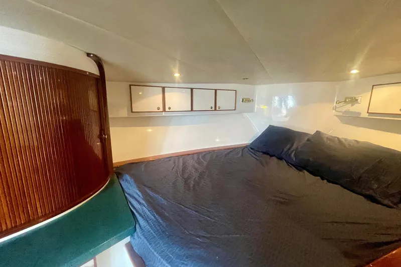 M.a.c. Daddy Yacht Photos Pics Cozy cabin interior of 2005 Custom DeSanti Carolina Express boat with bed and storage cabinets.