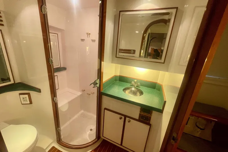 M.a.c. Daddy Yacht Photos Pics 2005 Custom DeSanti Carolina Express bathroom with shower, sink, and wooden accents.