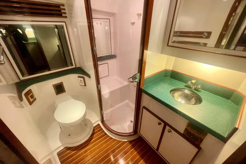 M.a.c. Daddy Yacht Photos Pics Luxurious 2005 DeSanti Carolina Express bathroom with shower, toilet, and sink.