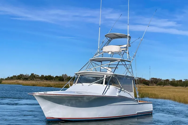 M.a.c. Daddy Yacht Photos Pics 2005 Custom DeSanti Carolina Express boat on calm water under clear blue sky.