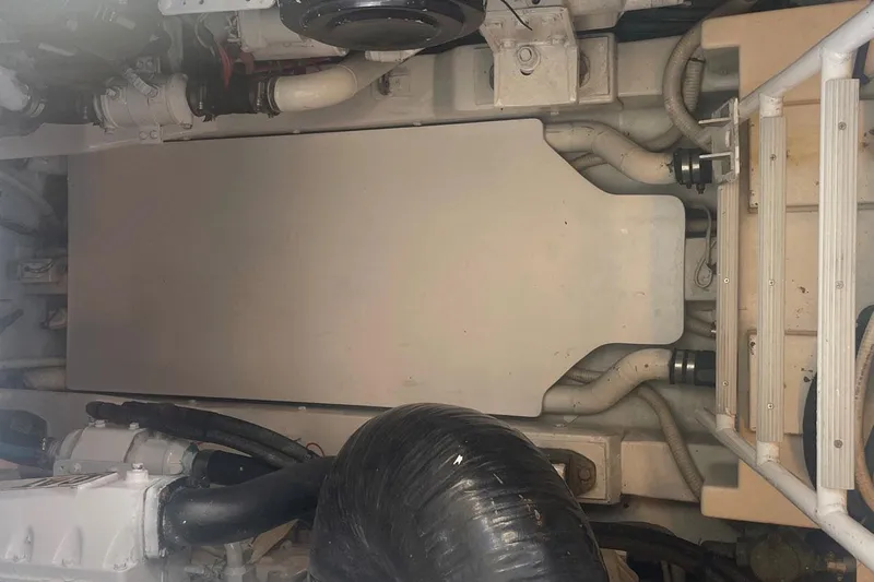 M.a.c. Daddy Yacht Photos Pics Engine compartment of a 2005 Custom DeSanti Carolina Express boat, showing hoses and components.