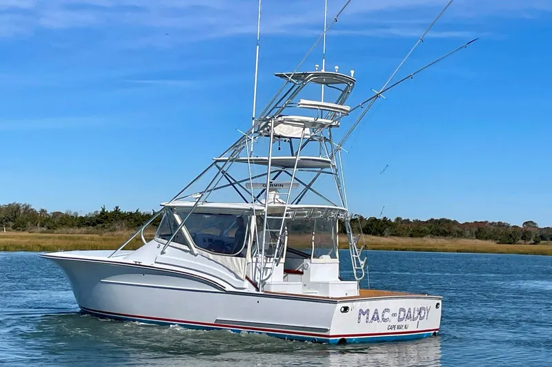 M.a.c. Daddy Yacht Photos Pics Custom 2005 DeSanti Carolina Express boat on water, clear sky background.