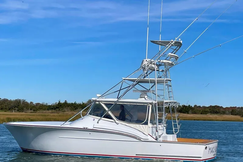 M.a.c. Daddy Yacht Photos Pics Custom 2005 DeSanti Carolina Express boat cruising on a calm waterway.