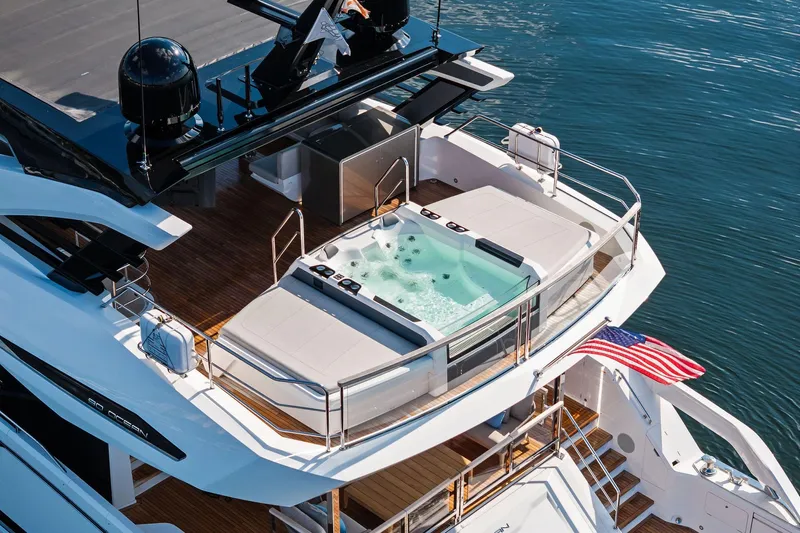 Don Tortuga Yacht Photos Pics Luxurious 2024 Sunseeker Ocean 90 yacht with jacuzzi and American flag on deck.