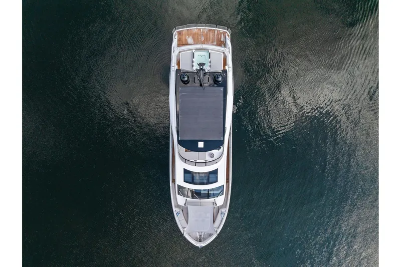 Don Tortuga Yacht Photos Pics Aerial view of 2024 Sunseeker Ocean 90 yacht on calm water.