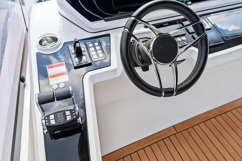 Don Tortuga Yacht Photos Pics 2024 Sunseeker Ocean 90 yacht helm with steering wheel and control panel.