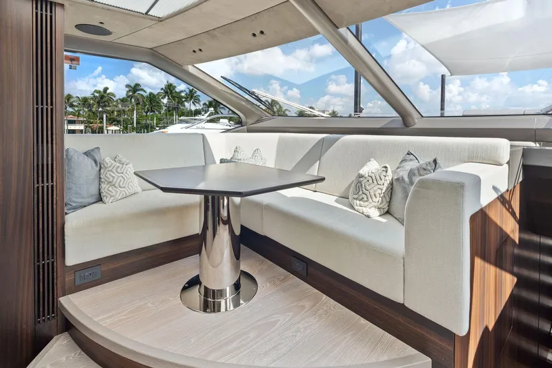 Don Tortuga Yacht Photos Pics Luxurious interior of 2024 Sunseeker Ocean 90 yacht with elegant seating and table.