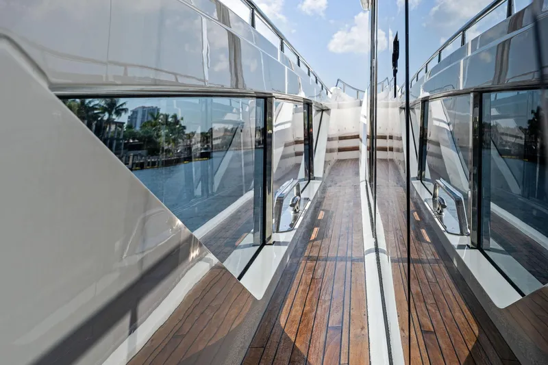 Don Tortuga Yacht Photos Pics 2024 Sunseeker Ocean 90 yacht deck with sleek reflective surfaces and wooden flooring.
