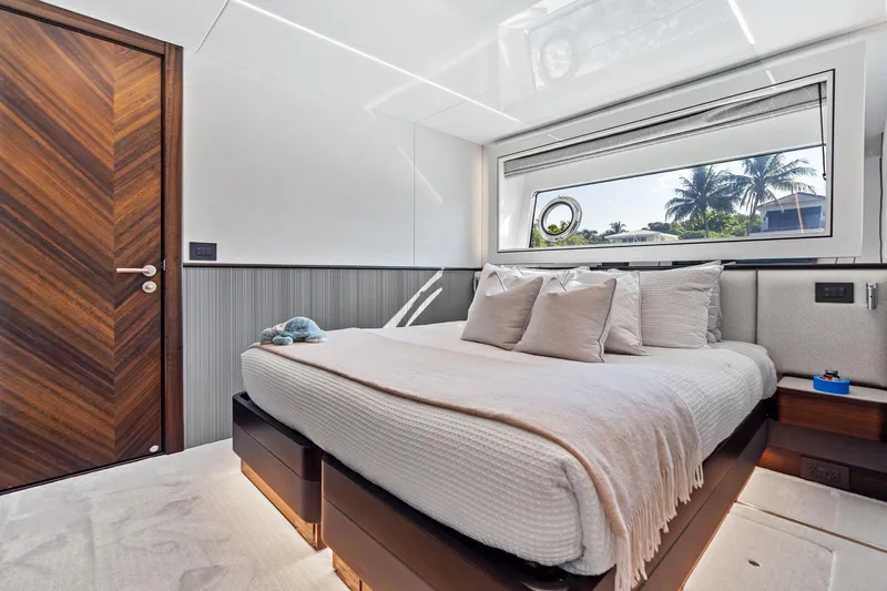 Don Tortuga Yacht Photos Pics Luxurious bedroom interior of 2024 Sunseeker Ocean 90 yacht with modern design and large window.