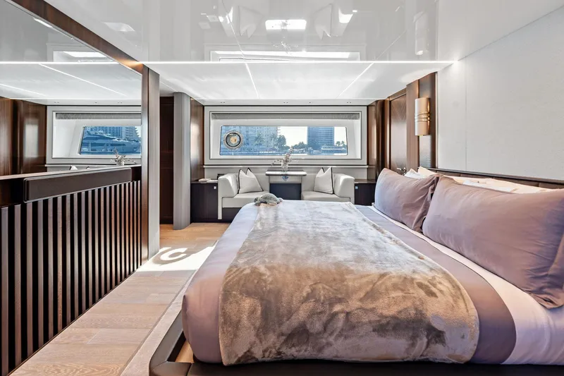 Don Tortuga Yacht Photos Pics Luxurious 2024 Sunseeker Ocean 90 yacht bedroom with elegant decor and large windows.