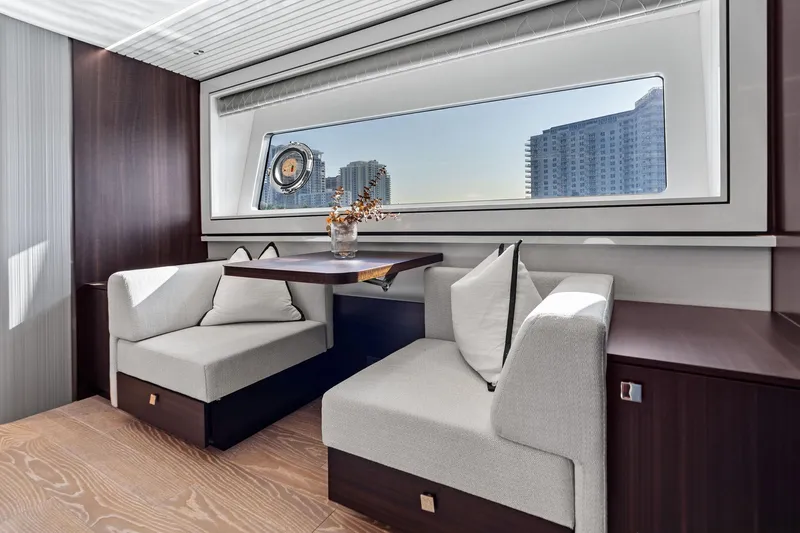Don Tortuga Yacht Photos Pics Luxurious interior of 2024 Sunseeker Ocean 90 yacht with elegant seating and city view.