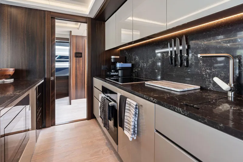 Don Tortuga Yacht Photos Pics Luxurious kitchen interior of 2024 Sunseeker Ocean 90 yacht with modern design and amenities.