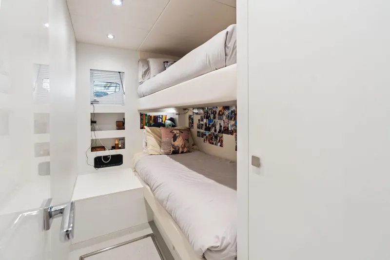 Don Tortuga Yacht Photos Pics 2024 Sunseeker Ocean 90 yacht cabin with bunk beds, cozy decor, and personal photos.