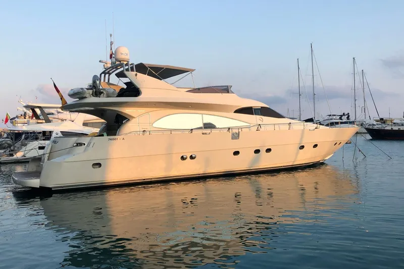  Yacht Photos Pics Luxury Mochi 2250 yacht from 2003 docked in a serene marina setting.