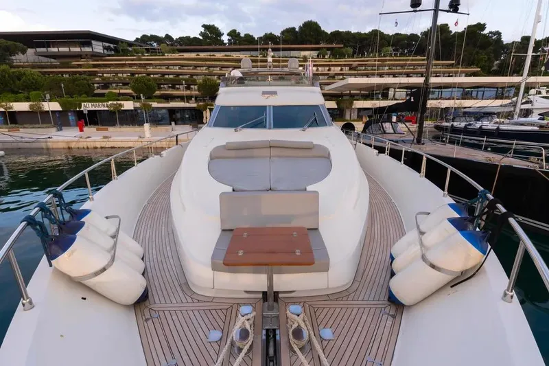  Yacht Photos Pics Luxury Mochi 2250 yacht docked at marina, showcasing sleek design and spacious deck.