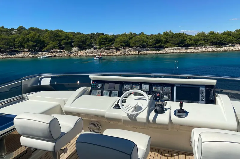  Yacht Photos Pics Helm of 2003 Mochi 2250 yacht with scenic coastal view.