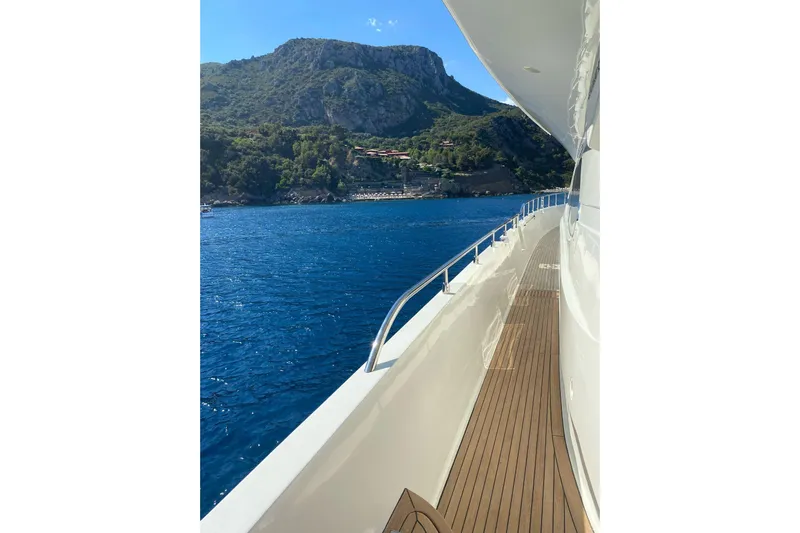  Yacht Photos Pics Side view of Mochi 2250 yacht, 2003 model, cruising near scenic coastline.