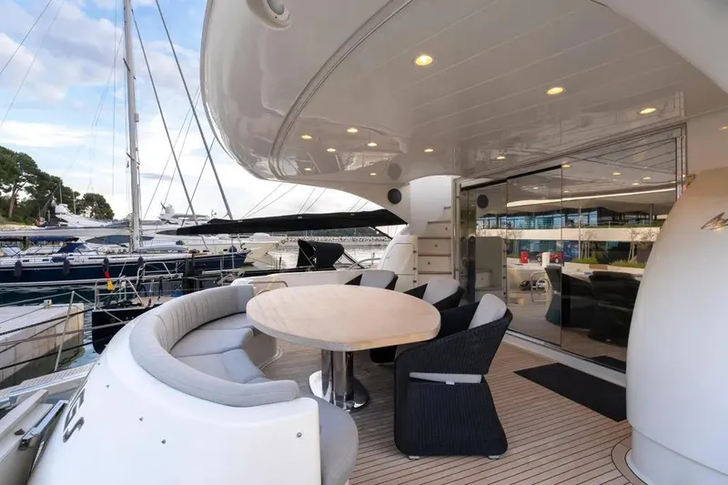  Yacht Photos Pics Luxury Mochi 2250 yacht deck with elegant seating, docked at marina, 2003 model.