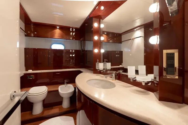  Yacht Photos Pics Luxurious yacht bathroom with elegant wood finishes, featuring a sink, toilet, and bidet. Mochi 2250, 2003.