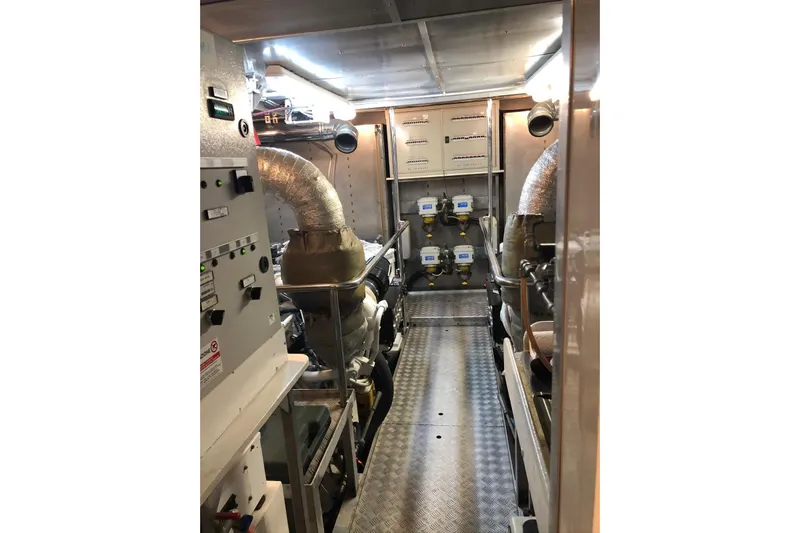  Yacht Photos Pics Engine room of a 2003 Mochi 2250 yacht, featuring machinery and control panels.