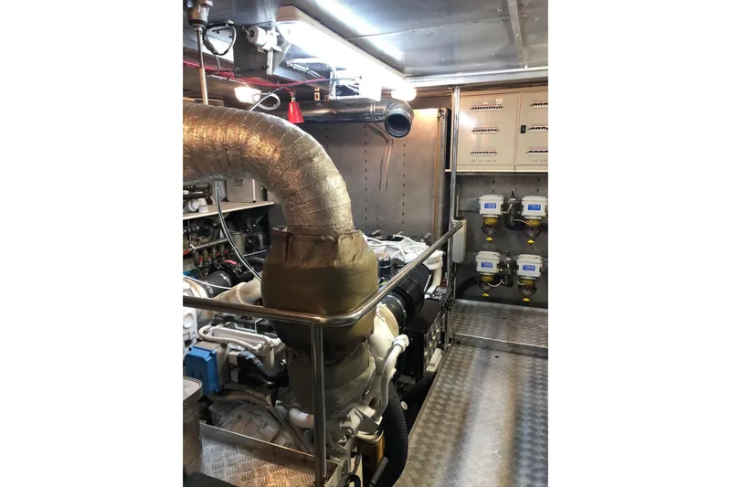  Yacht Photos Pics Engine room of a 2003 Mochi 2250 yacht, featuring machinery and control panels.