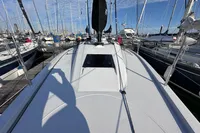 2022 Dehler 30 sailboat docked in a marina, surrounded by other boats under a clear sky.