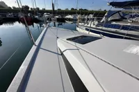 Dehler 30 sailboat, 2022 model, docked in a marina under clear blue skies.