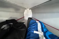 Interior storage space of a 2022 Dehler 30 sailboat with bags.